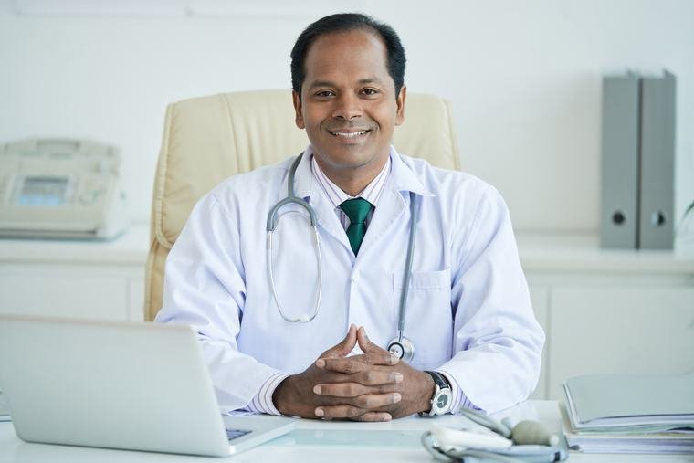 Senior physician at his desk in a small hospital